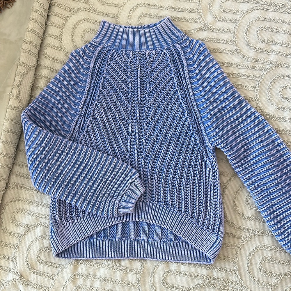 Distressed knitted sweater.